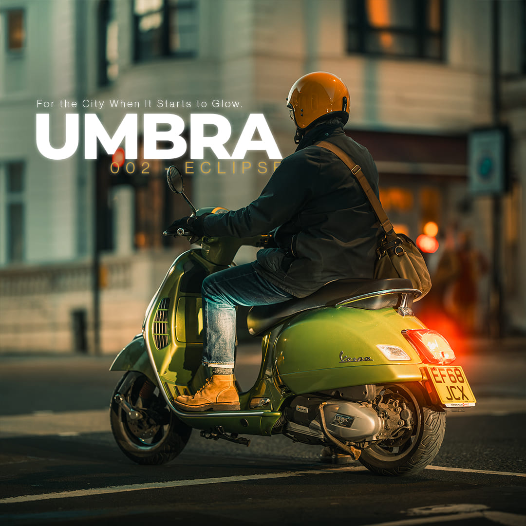 Scooter rider on city street at night edited with UMBRA preset from ECLIPSE Cinematic Lightroom Pack